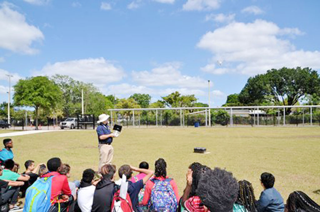 Photo of Patrick Phillips demonstrating his drone skills in the school yard.