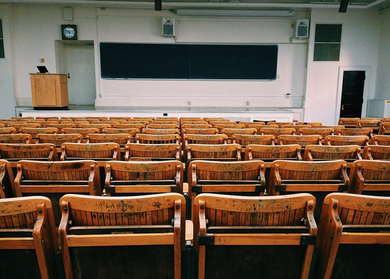 classroom with empty chairs and blackboard