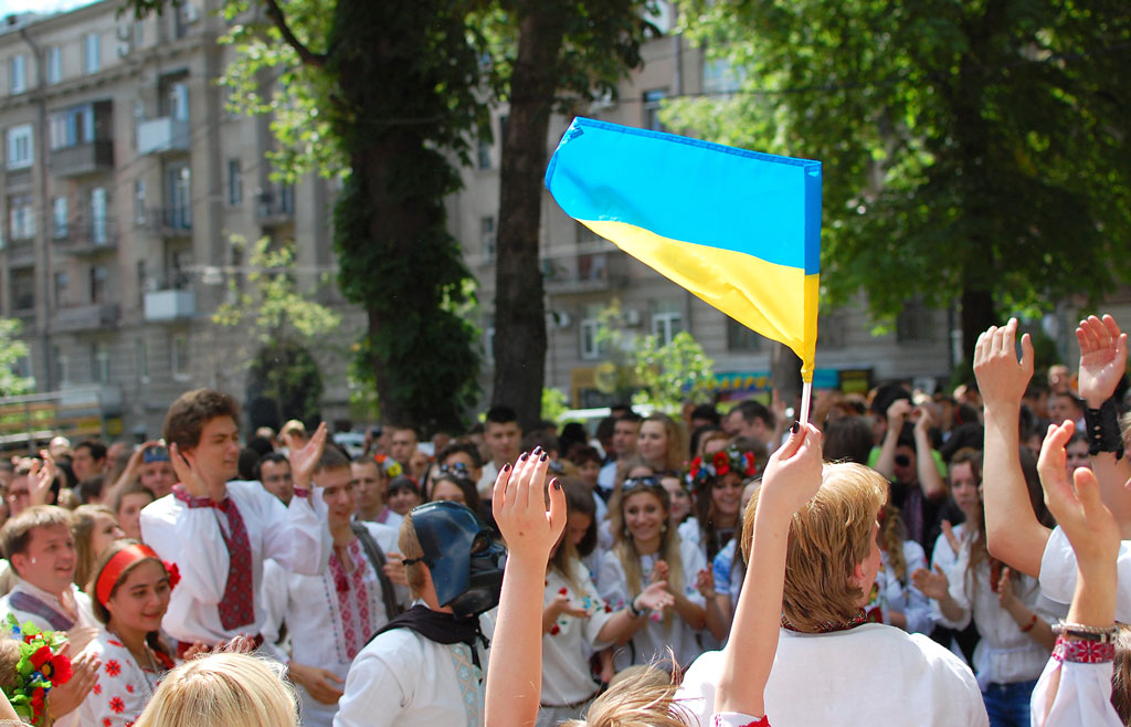 A person waves the Ukrainian flag during a parade by Vladimir Yaitskiy