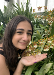 Photo of Bettina Saradaroglu posing with flowers