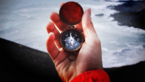 Photo of hand holding a compass; credit Garrett Sears, unsplash.com