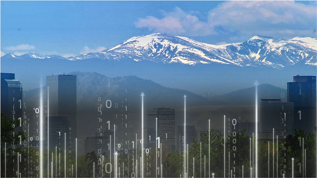 Digital arrows and numbers imposed on the Denver skyline with Rocky Mountains in background