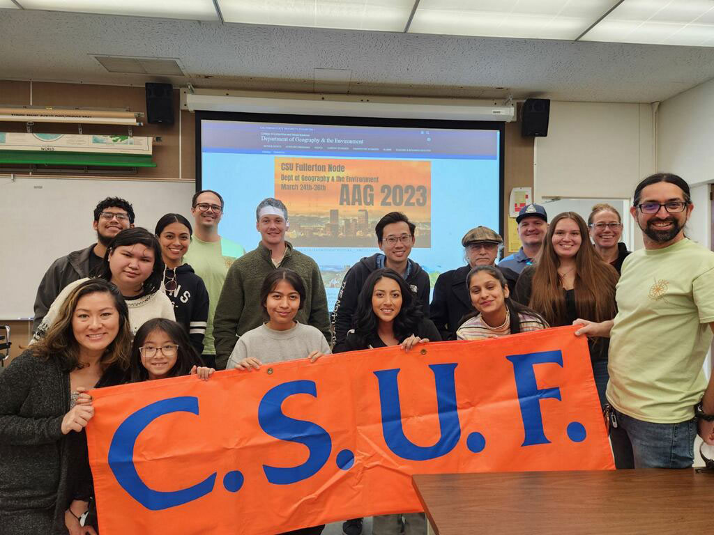 Attendees gather for a group photo to show their school pride during a break at the California State University, Fullerton AAG 2023 node of events.