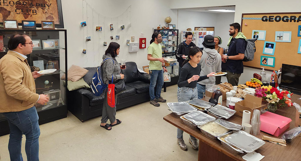 Attendees enjoy some food during a break at the California State University, Fullerton AAG 2023 node of events.