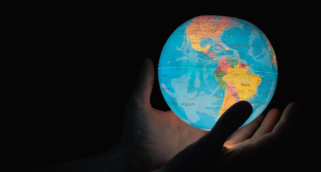 Photo of hand holding glowing globe by Greg Rosenke for Unsplash