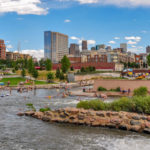 Confluence Park rapids and beach with a backdrop of the Denver Skyline by Kent Kanouse, Creative Commons