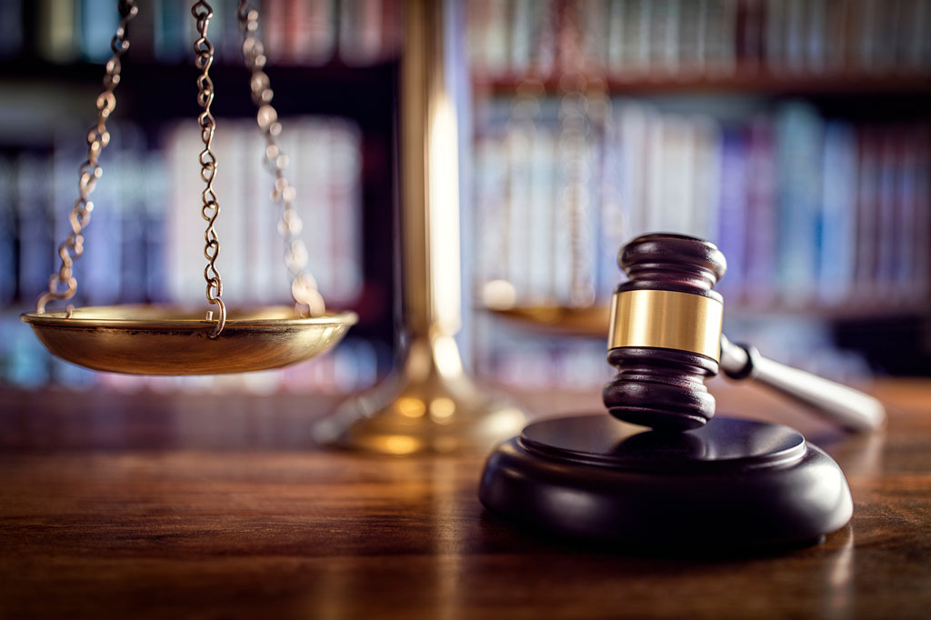 Scales and gavel on table symbolizing justice, ethics, human rights