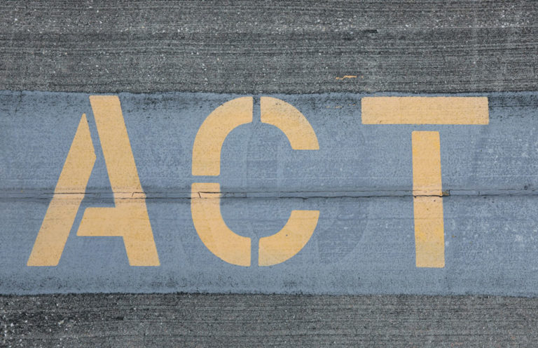 Image of the word ACT spray-painted on cement by Mick Haupt for Unsplash