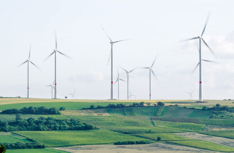 Photo of wind turbines on a farm by Karsten Wurth for Unsplash