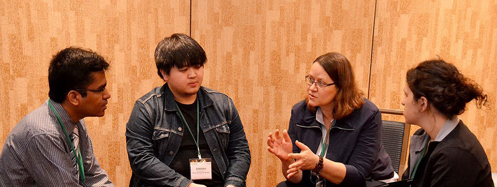 Photo of a mentor and mentees talking during breakout group within a career mentor session