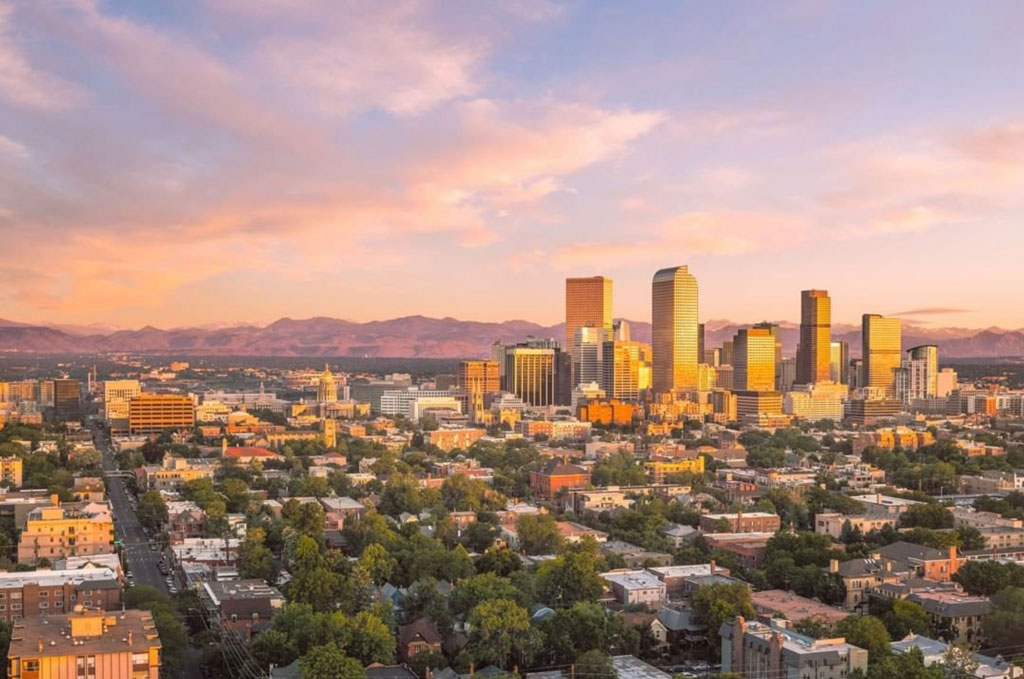 Aerial view of downtown Denver with mountains in the background. Credit: CANUSA Touristik via denver.org