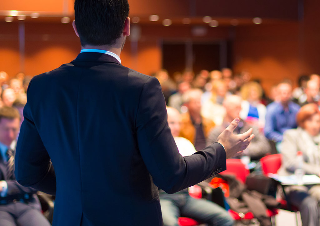 Photo of man speaking to audience