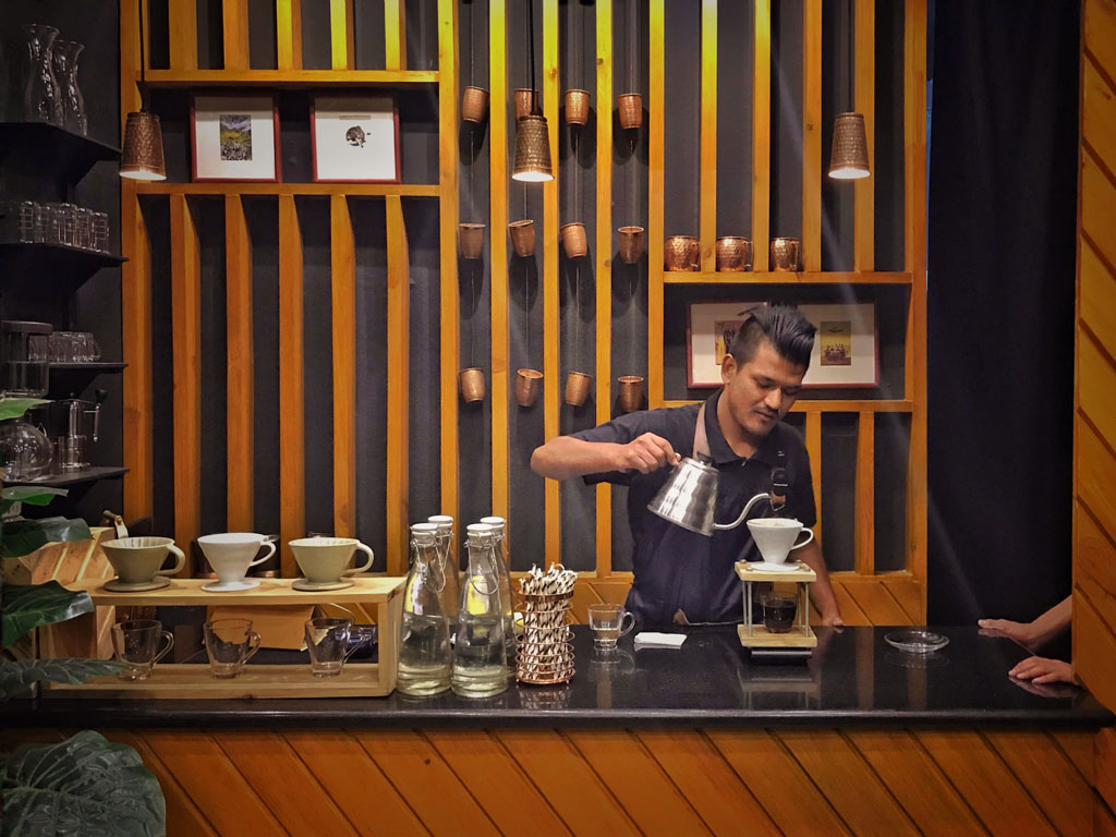 Photo of barista preparing a beverage in Kathmandu, Nepal. Credit: Rohit Khadgi