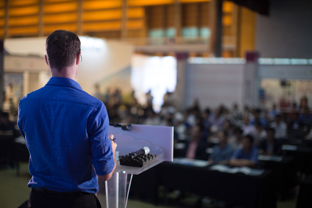 Man presenting to a large audience