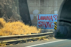 Local resident's tribute of tagging "Lahaina Strong" on a wall beside a road. Credit: State Farm Insurance