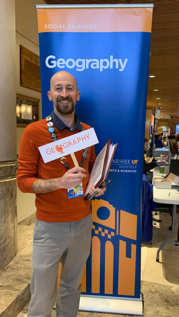 Michael Camponovo stands near the University of Tennessee Knoxville's information table during GIS Day 2019