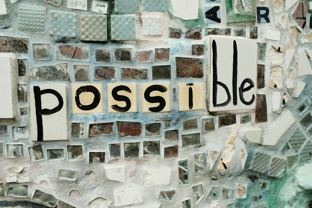 Stylized tile wall with "possible" spelled out; credit: Chang Ye, Unsplash