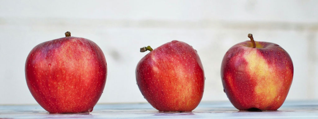 Apples lined up on a flat surface; Credit: Isabella Fischer, Unsplash