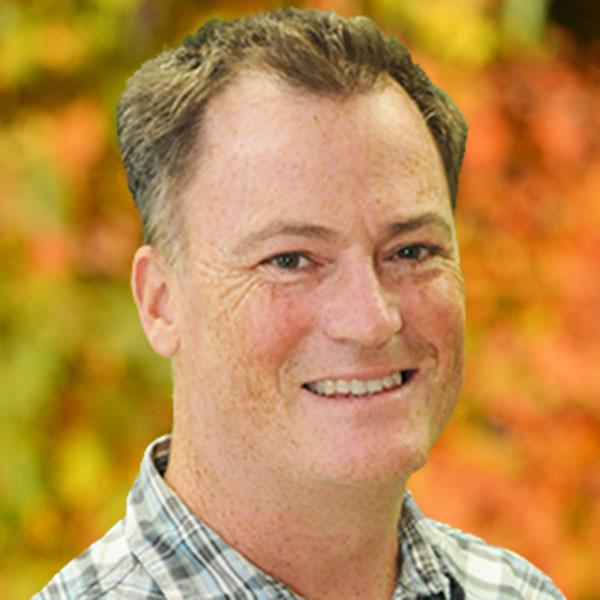Matthew McCourt portrait with a background of fall leaves