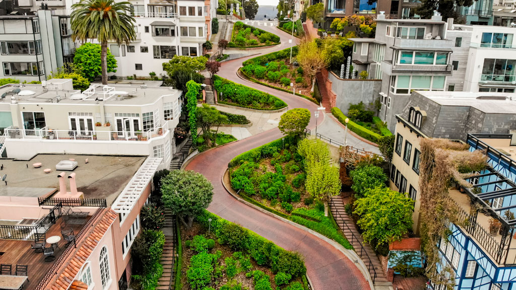 Aerial photo showing the curve of Lombard Street winding down the hill between homes