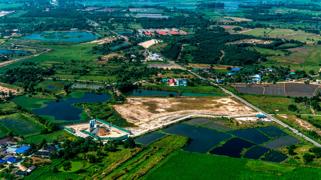 Aerial photo of green fields and trees under blue sky with white clouds. Credit: Tom Fisk, Pexels