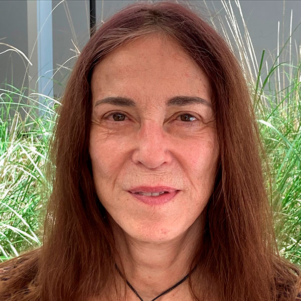 Judith Carney is pictured in front of ornamental grasses