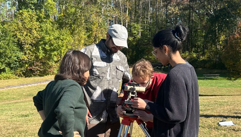 GGS students gather data with a transit device to create contour maps of a local park in GGS as part of their field mapping class.