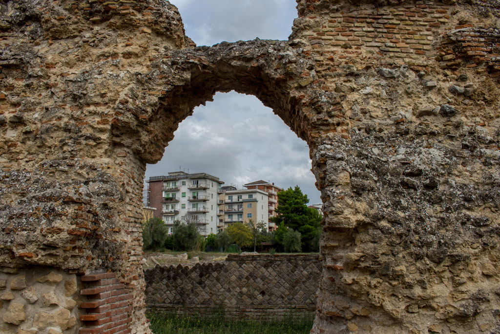 Larino, Campobasso, Roman archaeological site on the modern building background, on a sunny day